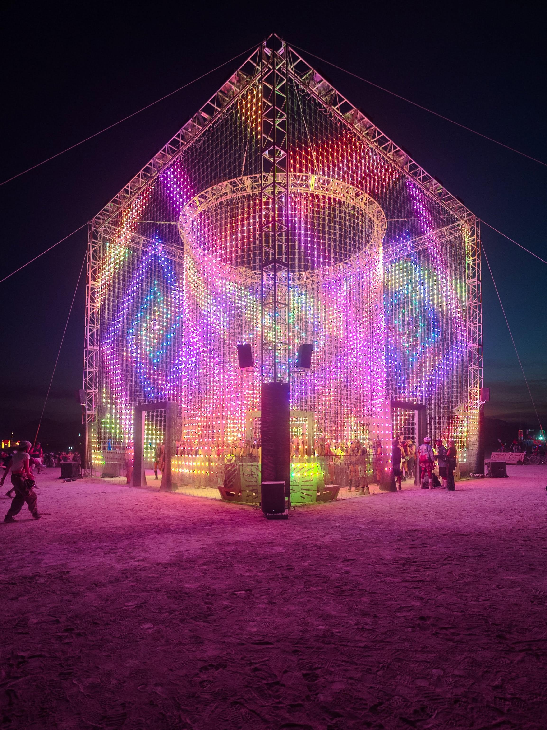 Apotheneum illuminated at night at Burning Man